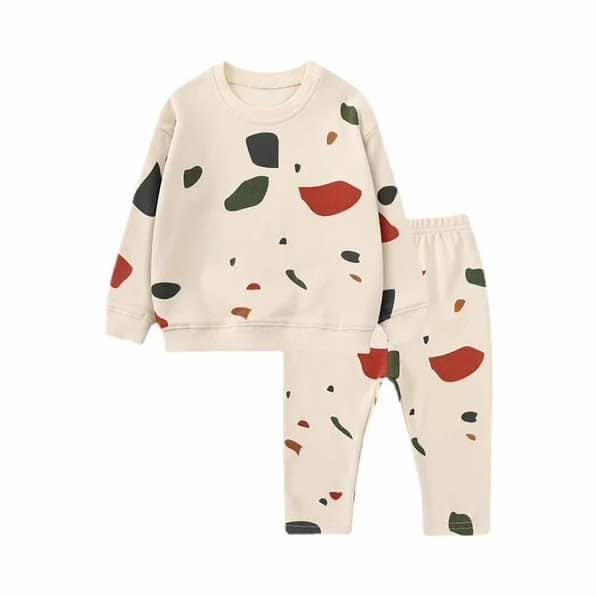 Toddler lounger set in abstract print displayed on a white background. sweatshirt and leggings set in beige with dark green, black and terracotta shapes.