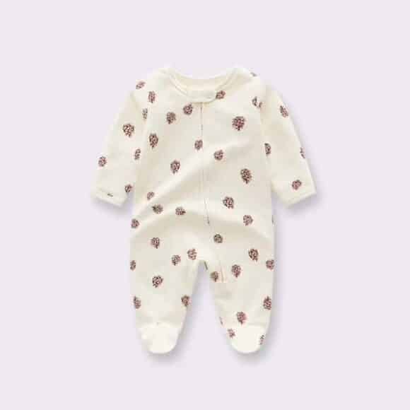 baby full body romper is displayed on white background. the romper has feet and hand coverings, it is in a light cream colour and has a neutral floral pattern.
