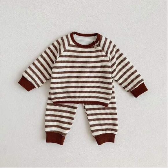 Waffle cotton texture sweatshirt and pants displayed on white background. kids set in a brown and white stripe.