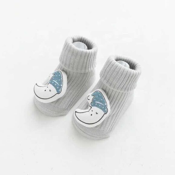 baby socks with sole grips and teddy on the toes in shape of a moon with a face displayed on white background