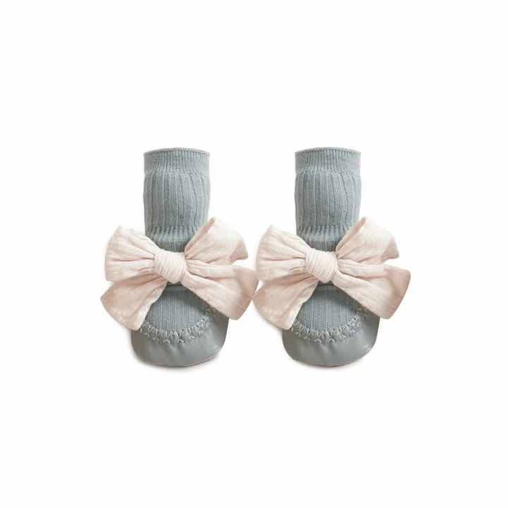 girls baby sock slippers in blue with white bow on white background