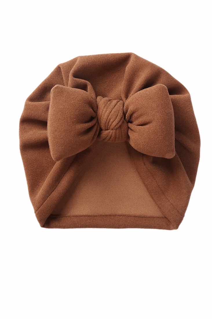 chocolate brown colour baby hat with big decorative bow at the front.