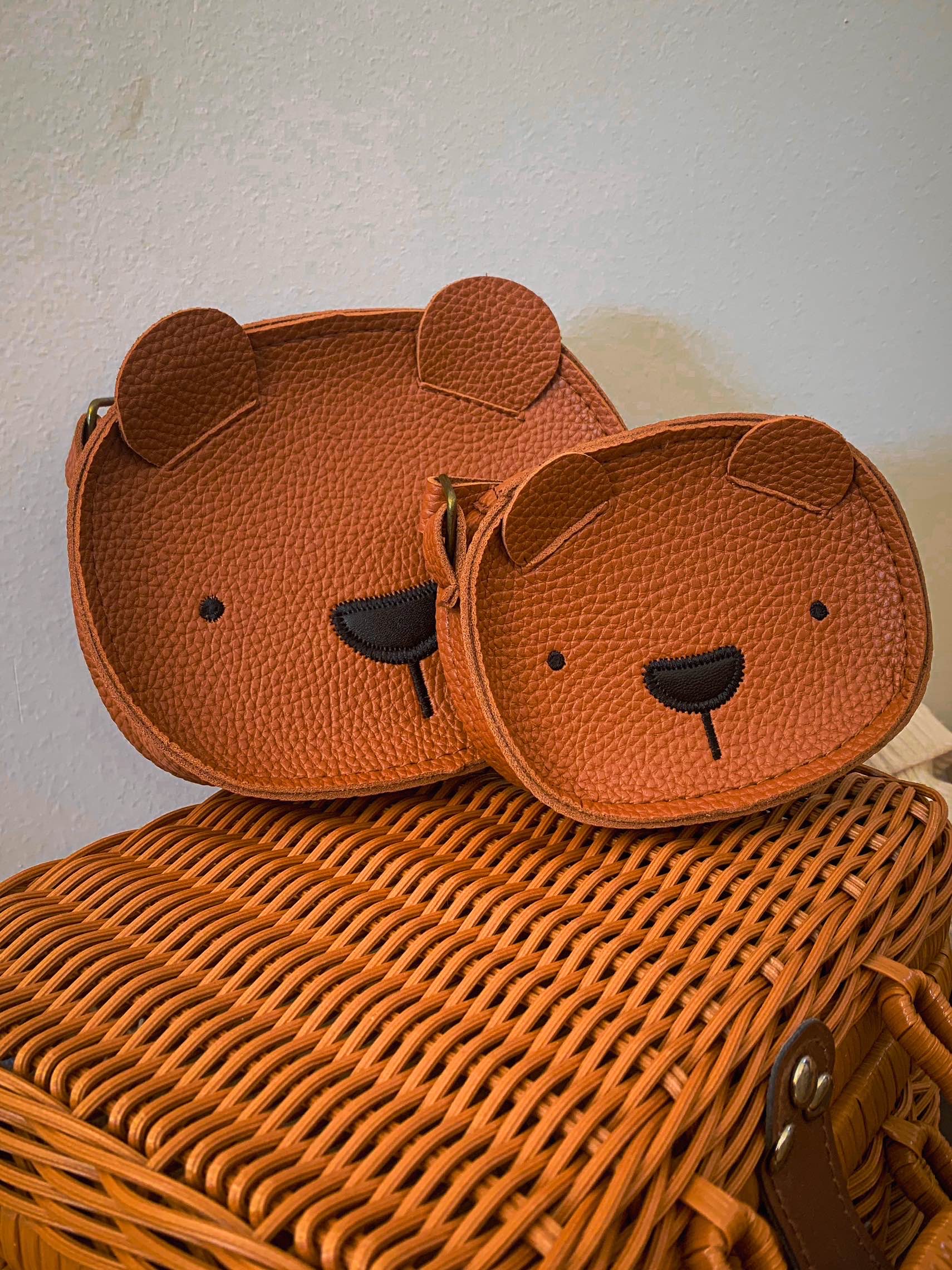 mommy and me mini coin purses in shape of a bear face in brown on a wicker basket