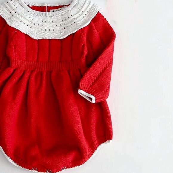 Red cotton knitted long sleeved baby girls romper. Christmas design. Knitted with a pattern on the top in plain red, collar is knitted and also lace style in white.