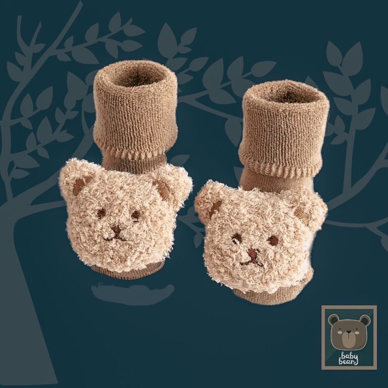fluffy and cute baby socks with big bear teddy attached to the front. the cotton socks are rolled over in the picture like a little baby bootie.