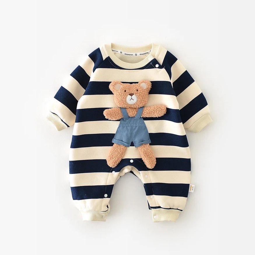 A winter baby romper with a teddy bear sewn to the front of the suit has been placed on a. clear white background for display. The cotton romper is in navy blue and cream stripes. Gender neutral.