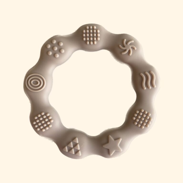 silicone ring for teething. there are 9 different sensory pieces on the ring that can be chewed and played with by the baby